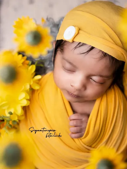 A close-up of the sunflower-themed newborn shoot, focusing on the baby's peaceful, sleeping face.