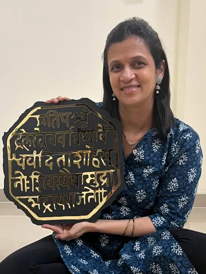 Here I am holding the custom Rajmudra piece from the UK order, featuring a striking black and gold design.