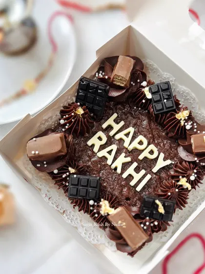 A 'Happy Rakhi' brownie slab, loaded with different chocolates. A fun and modern way to celebrate the festival.