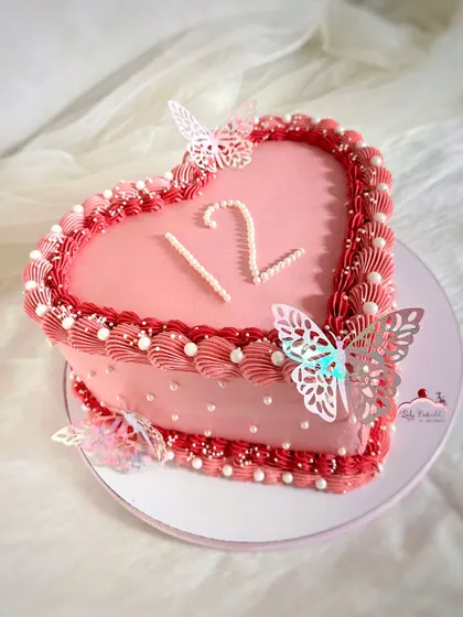A lovely vintage-style heart cake in shades of pink and red, decorated with delicate butterflies. This was a fresh mango cake, made when the king of fruits was in season.