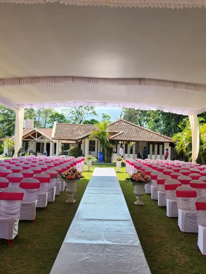 The guest seating and aisle leading up to the pink mandap. We ensure the entire ceremony space is cohesive, with chair sashes that match the color scheme and a clean white aisle runner.