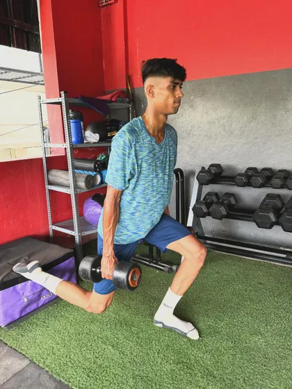 A young client performs a dumbbell Bulgarian split squat, developing balance and single-leg strength.