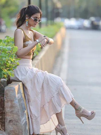 A candid, street-style shot of Shiwani Chakraborty. This captures a natural, in-between moment that feels authentic and unposed.