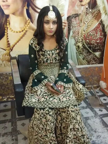The full view of the sharara suit look. The makeup and styling create a very regal and festive appearance.