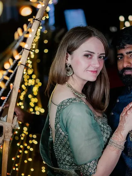 A beautiful portrait of the couple against a backdrop of fairy lights at their evening reception.