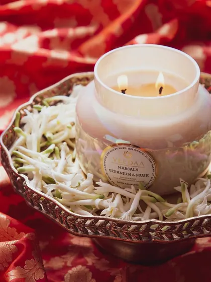 As the festive season approaches, make sure you're stocked up on your favorite Veedaa candles. Here, our Marsala Geranium & Musk candle is presented beautifully on a traditional platter.