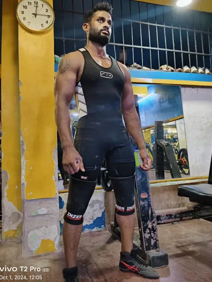 Geared up and ready to lift. Wearing an SBD singlet and knee sleeves, this student shows the physique of a competitive powerlifter.