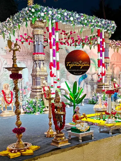 A close-up of a brass deepam and other traditional props, showcasing the golden glow and warmth they bring to an event.