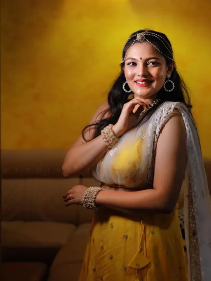 A perfect Haldi look for our bride Dhruthi. This bright yellow lehenga with a sheer white dupatta is light, happy, and just right for the joyous celebration.