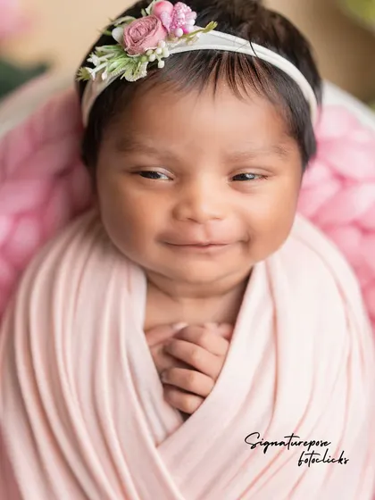 The precious, open-eyed smile of a 20-day-old newborn, a rare and treasured moment captured forever.