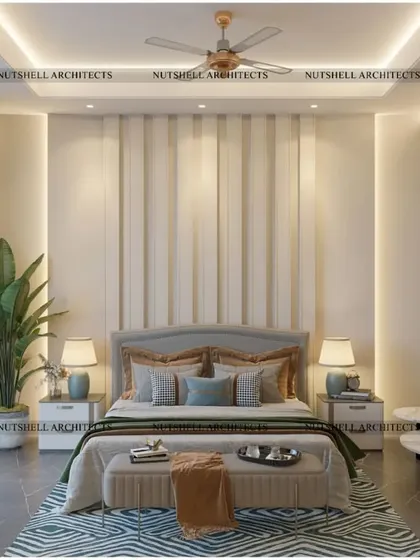 The bed in this parent's suite is set against a backdrop of elegant upholstered panels. A small, comfortable seating area by the window provides a perfect spot for morning coffee or quiet reading.