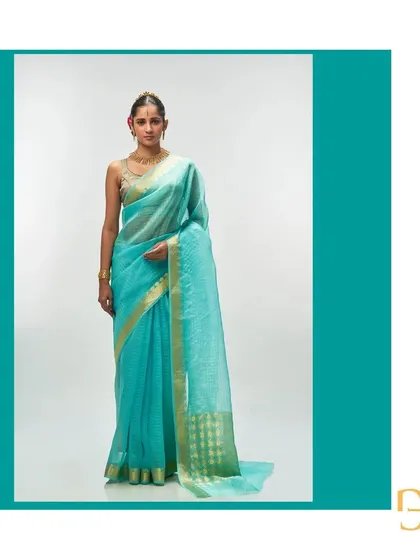 A full-length view of the aquamarine saree, showcasing its refreshing color and delicate craftsmanship.