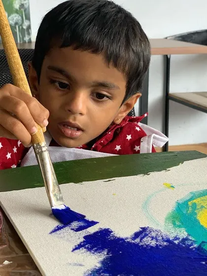 Another little artist completely focused on his masterpiece. Our workshops are designed to let kids' imaginations run wild.