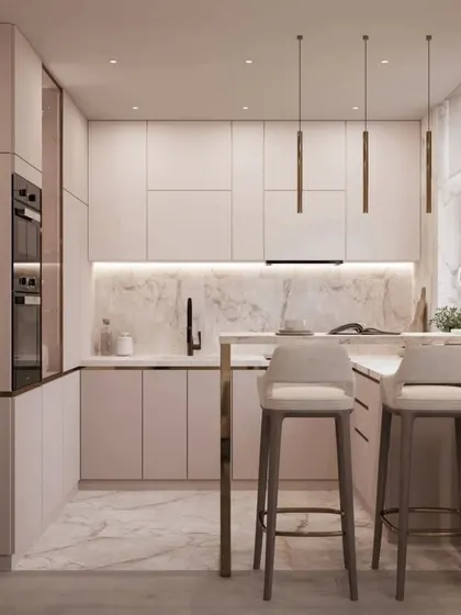 Another view of the pink kitchen, showing the integrated appliances and handleless cabinets that contribute to its sleek and modern design.