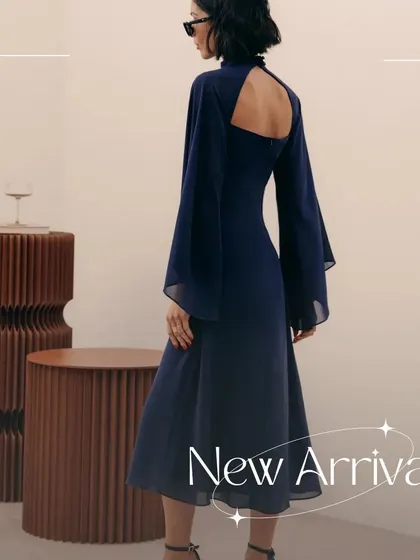 A look at the back of my signature Armani dress. The design features dramatic, flowing sleeves made from delicate organza and an open back, creating a sophisticated and modern statement for any special occasion.