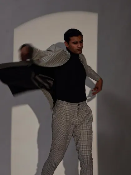 This image captures the fluid motion of a lightweight suit, demonstrating a relaxed yet put together approach to modern menswear.