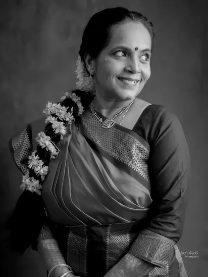 A stunning black and white portrait of a woman celebrating her 25th anniversary, her joy shining through.
