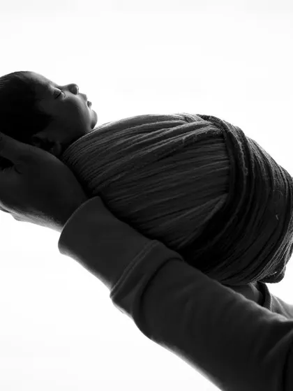 A precious gift. This minimalist black and white silhouette focuses on the shape and form of a baby being held, creating a timeless and emotional image.