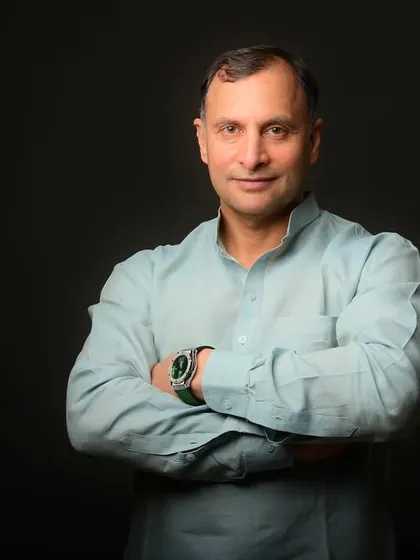 A strong, confident portrait of a political figure against a dark backdrop. This classic headshot style is designed to convey seriousness and determination.