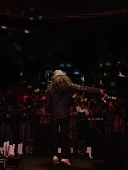 Pointing out to the crowd, getting them involved in the show. Interaction is key to building energy during a college performance.