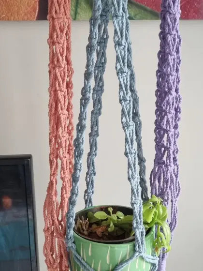 Give your plants a beautiful floating home. I create these macrame plant hangers in a variety of colors, like the soft pink, gentle blue, and lavender shown here. They are a simple way to add a touch of green and handmade warmth to any room.