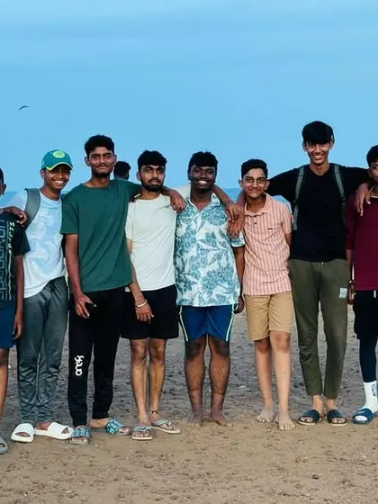 The team poses for a group photo at the beach in Chennai, capturing memories from their tour.