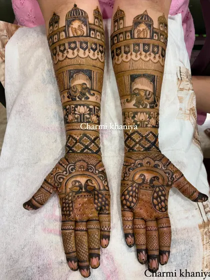 A stunning design for the groom's mother, featuring royal elephants inside palace windows and peacocks on the palms. This is a full, rich design that shows her importance in the celebration.