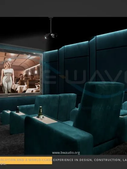 This custom theater in deep teal offers a unique and luxurious color palette. The design features wide, comfortable recliners with integrated tables, set against acoustically paneled walls for superior sound quality.