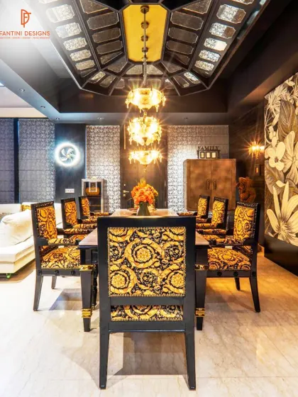 This dining room is pure drama and luxury. The Versace-inspired fabric on the chairs, the intricate ceiling detail, and the floral wall mural combine to create a truly opulent dining experience.