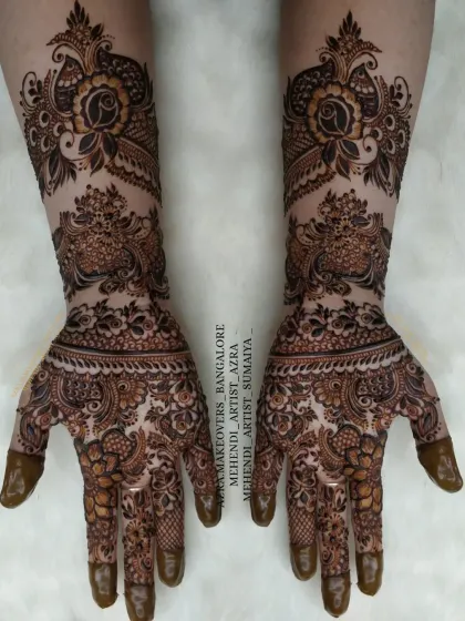 This design features bold peacock-inspired patterns on the forearm, combined with intricate work on the palms.