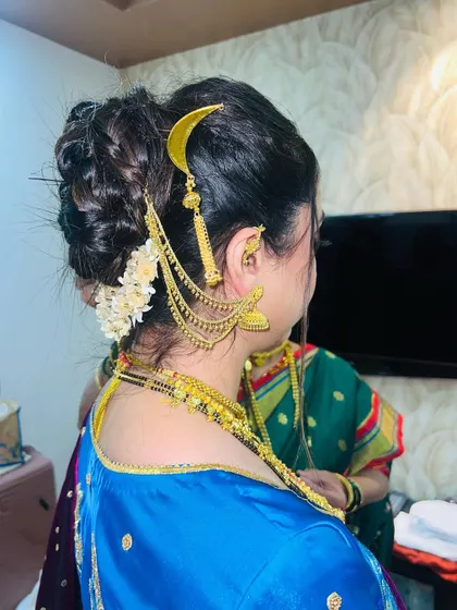 Another angle of the intricate khopa bun, showing how the hair accessories are placed.