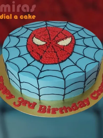 A simple yet striking Spider-Man cake. This design focuses on the iconic spider symbol on a web-covered blue background, making it a cool and graphic choice for a third birthday.