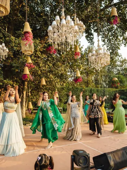 The bride's family and friends performing for her at this beautiful outdoor Mehendi. The joy is palpable.