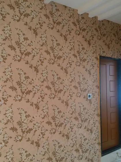 A delicate floral vine wallpaper in brown and beige tones. This classic design adds warmth and a touch of nature to the room, making it feel cozy and inviting.