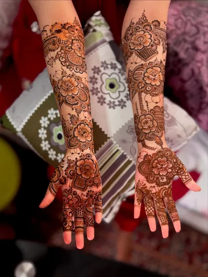 A stunning floral bridal design for bride Huma. The pattern features large, bold flowers that cascade down the arms, creating a very romantic and feminine look.