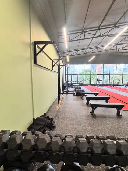 A look at our gym floor, set up for a group class. We have top-of-the-line equipment, including dumbbells, gymnastic rings, and a dedicated turf area.