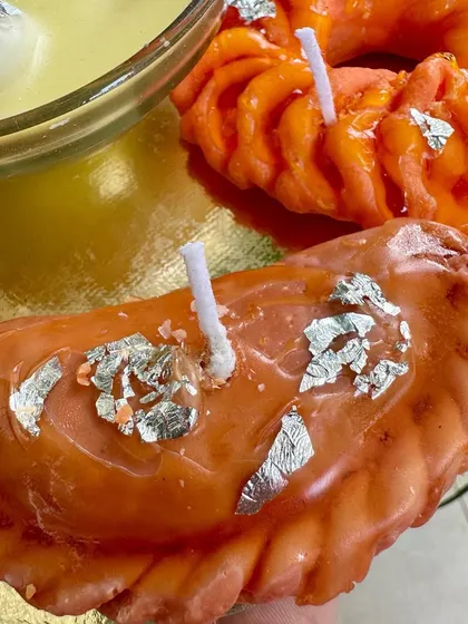 Say hello to my gujiya candle. This soy wax creation is glazed and detailed to look so real you'll be tempted to take a bite. It's a unique piece for any festive platter.