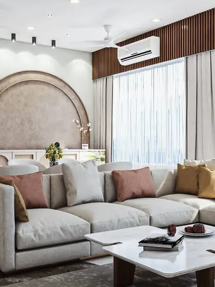 In this living area, we created a unique focal point with a large, upholstered arch behind the console table. Paired with a comfortable L-shaped sofa and warm, earthy tones, the design feels soft, inviting, and architecturally interesting.