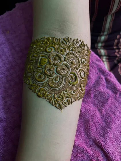 A close-up of the armband portion of the design. The details are incredibly fine, with delicate swirls and floral motifs.