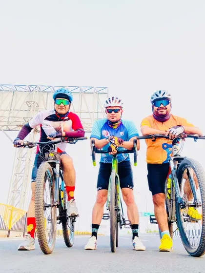 The trio of cyclists posing with their bikes. We are a team, on and off the road.