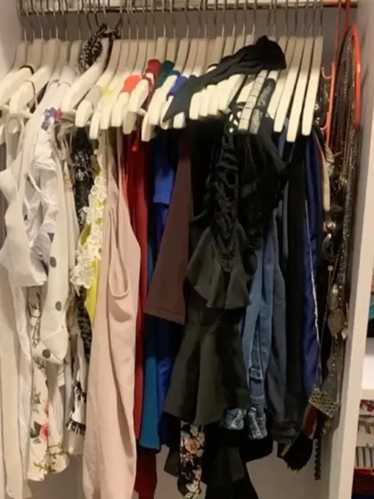A view of a client's closet before we optimized the space. The bulky hangers and lack of organization made it difficult to find things.