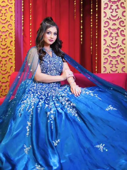 Seated in the royal blue ball gown, this shot shows the volume and richness of the fabric.