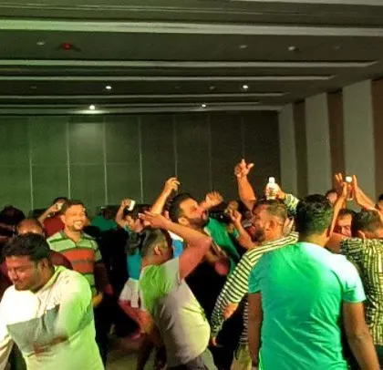 The party is in full swing, with guests dancing and enjoying themselves.