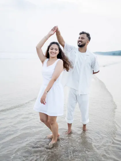 A happy, dancing moment in the shallow waters of the beach, full of life and joy.