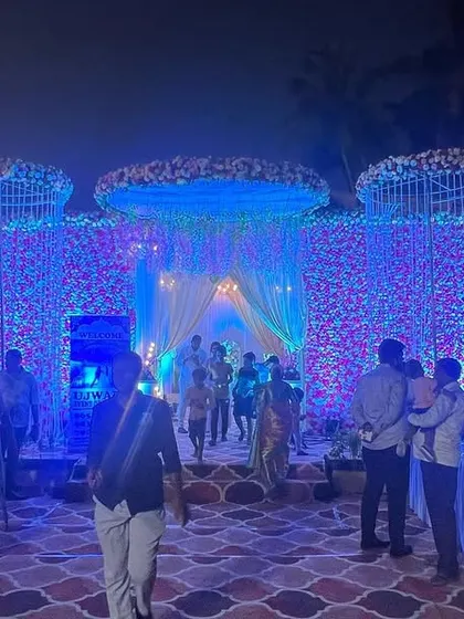 The same floral wall from the daytime setup, now completely transformed by night. I used dramatic blue uplighting to give the flowers a magical, otherworldly glow for the evening reception.