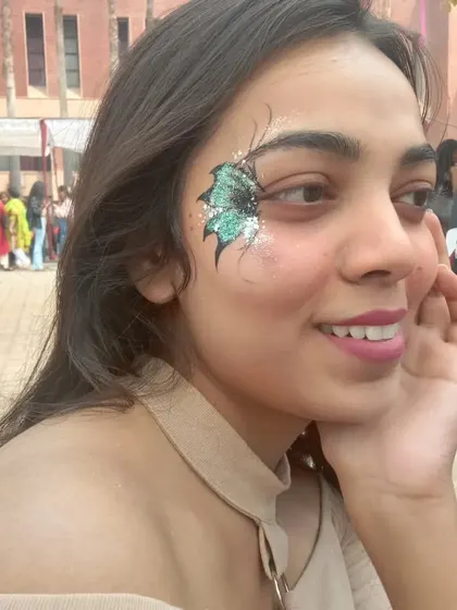 This design shows how a simple butterfly can be enhanced with a touch of glitter, creating a beautiful shimmer around the eye.