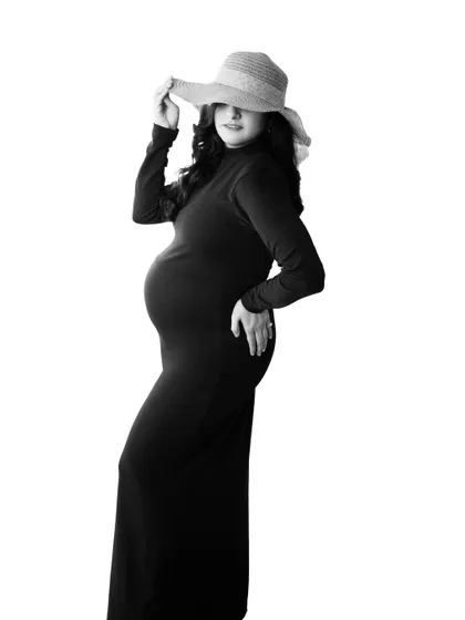 Elegance in simplicity, strength in motherhood. This monochrome shot in a black dress and hat is a perfect blend of grace, mystery, and quiet power.