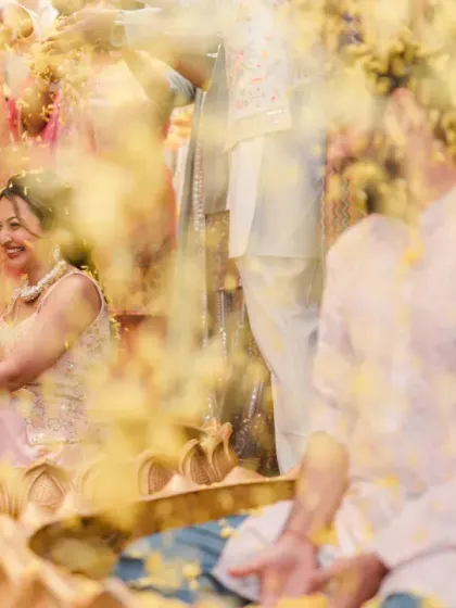 A dreamy, artistic shot of the couple amidst a shower of yellow petals. The motion blur creates a beautiful, ethereal effect, capturing the magic of the moment.