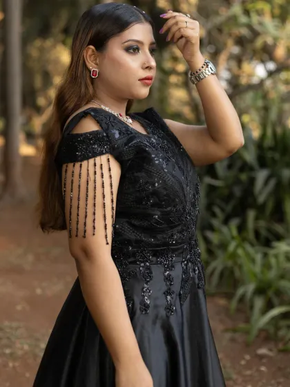 A closer look at the handwork on my black off-shoulder gown. The intricate beading on the bodice and the tassel sleeves add a touch of unique glamour.