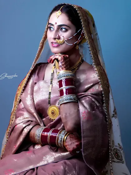 A three-quarter length portrait of the bride in a beautiful silk saree, showcasing a different style of bridal wear.